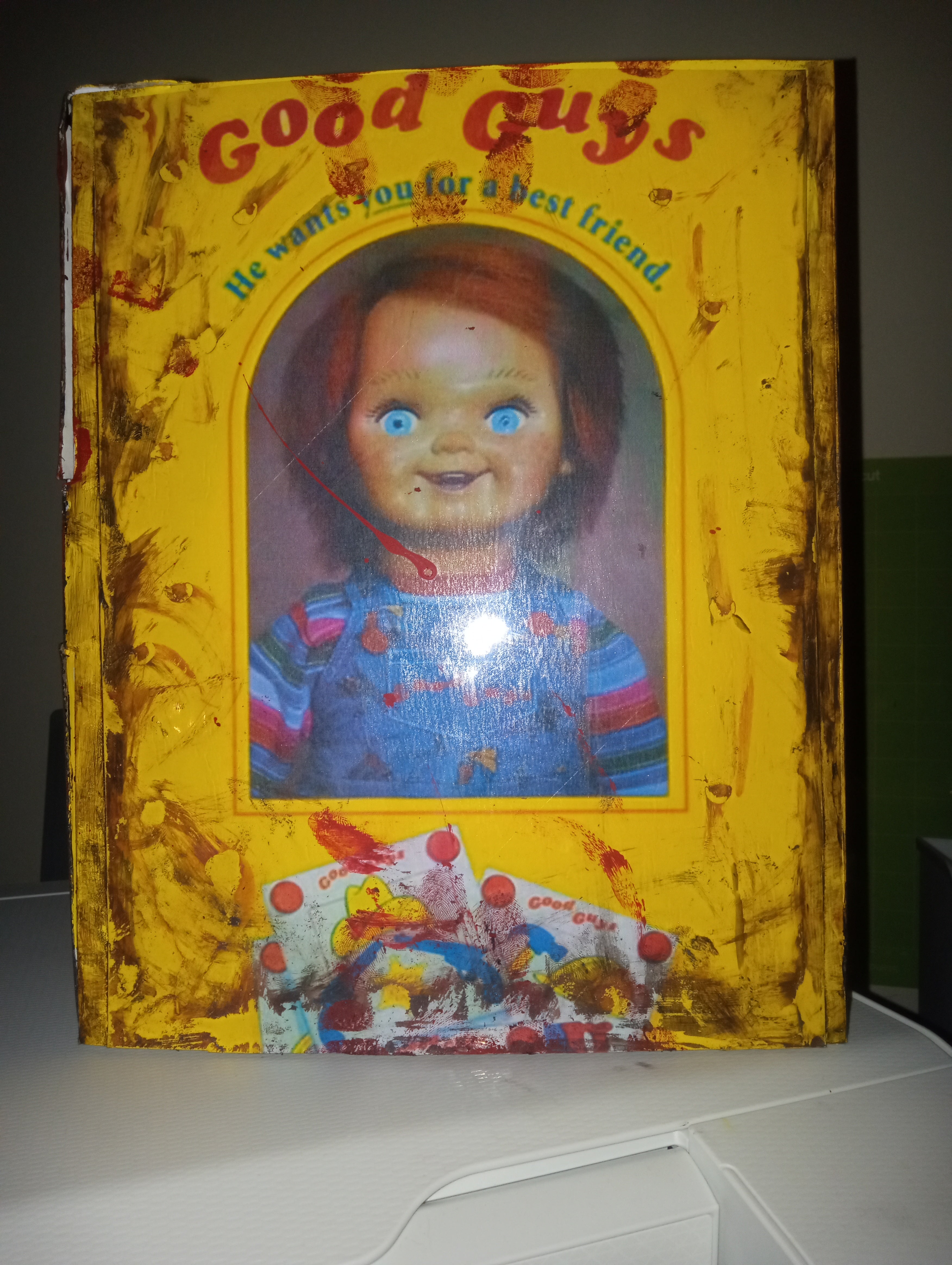 Toy box with a doll's face on the cover, featuring a yellow background and colorful design.