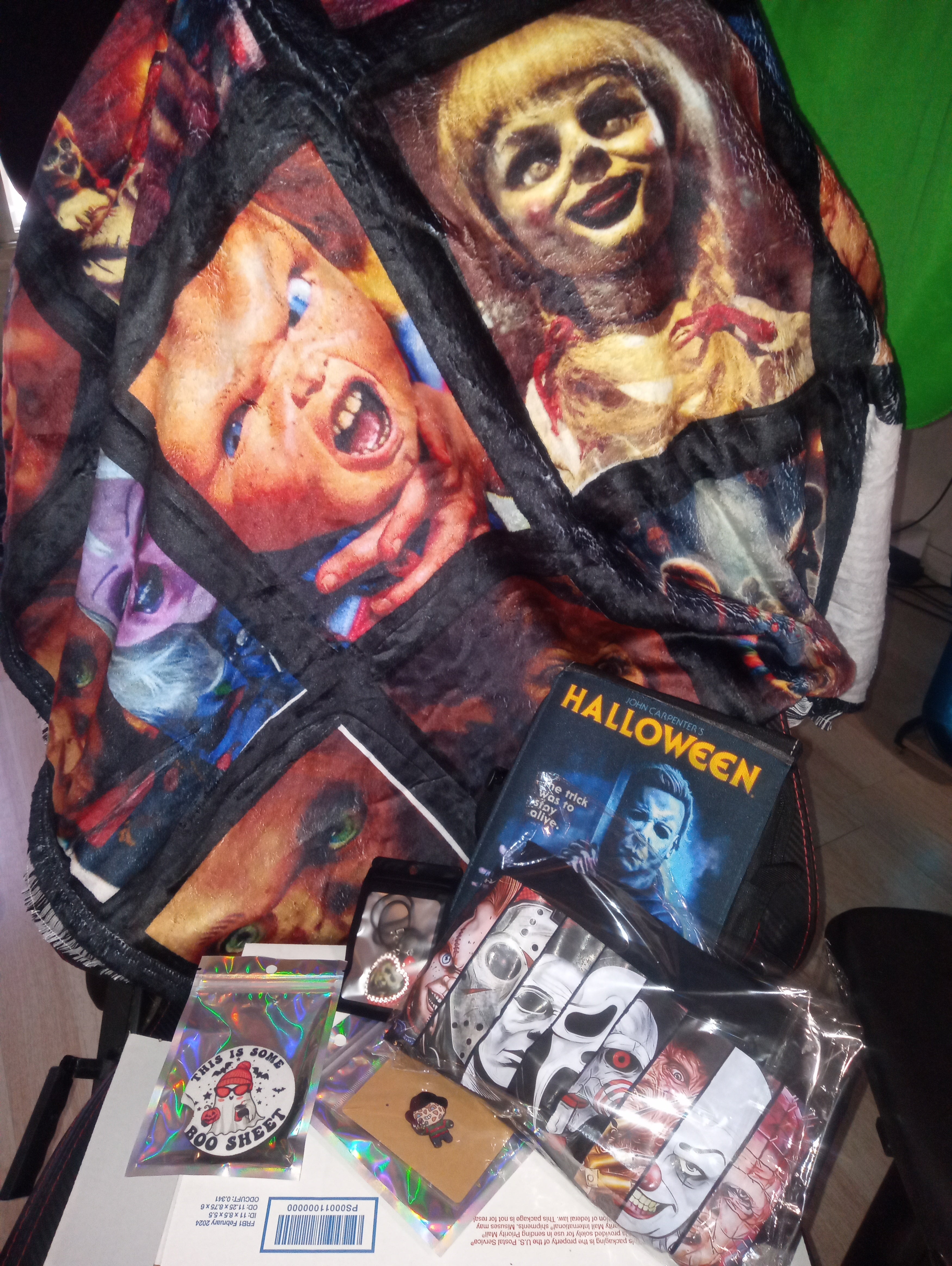 Halloween-themed product packaging with graphic designs on a table.